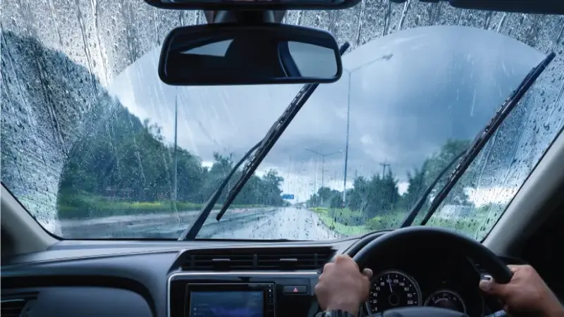 Bosch wiper blades cleaning windshield of car